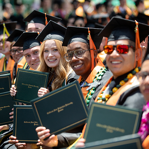 A group of graduates smile during the 2022 College of Science Commencement Ceremonies.
