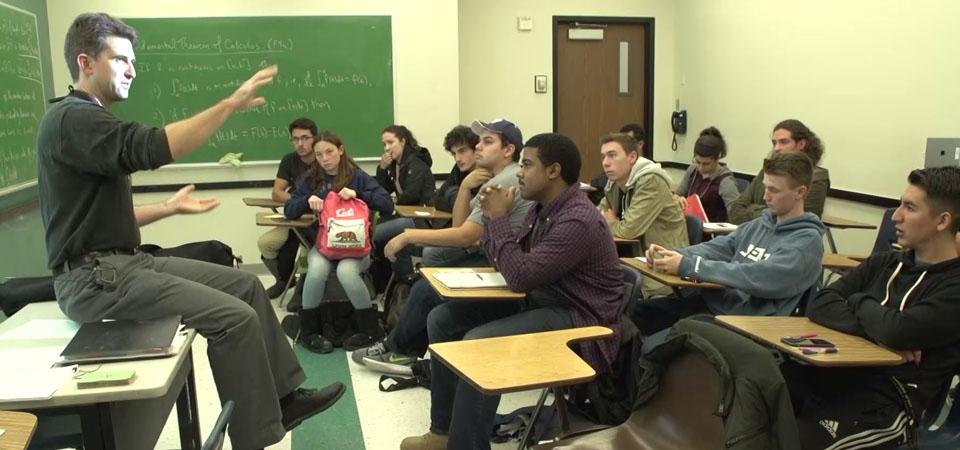 Arlo in classroom explaining to students