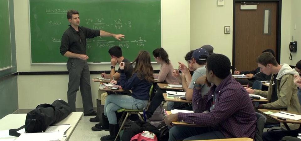 Students in Classroom with Professor Arlo Caine teaching