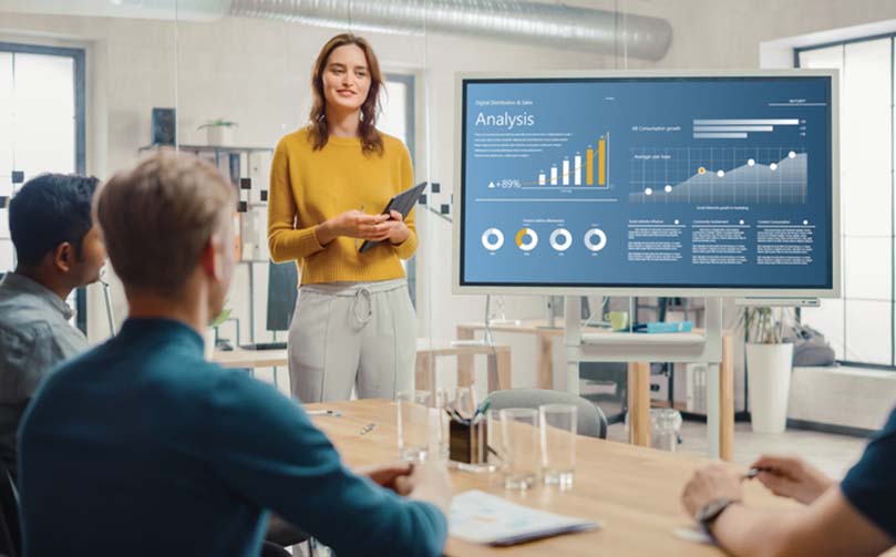 person presenting numbers on a screen