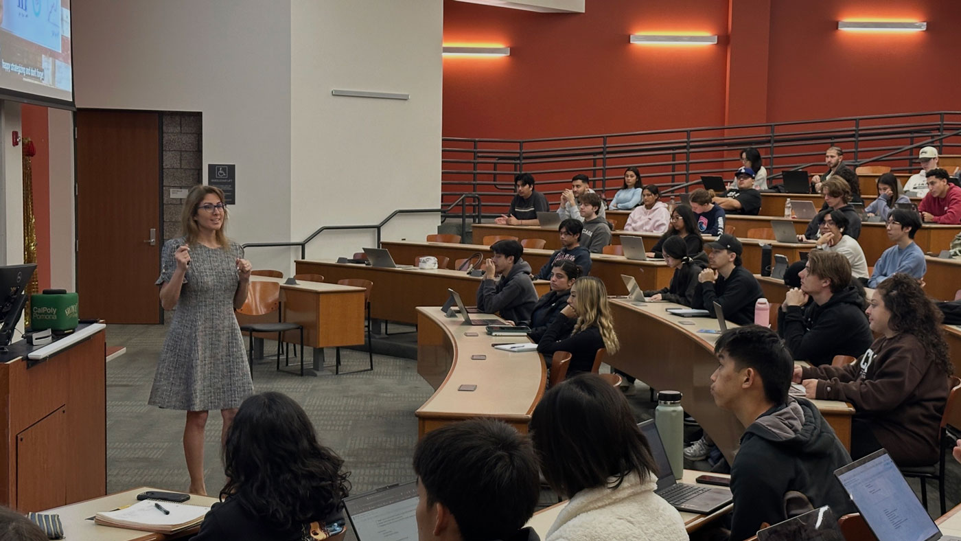 team in a meeting and person standing in front of a white board