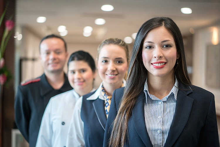group of hospitality workers standing in a line