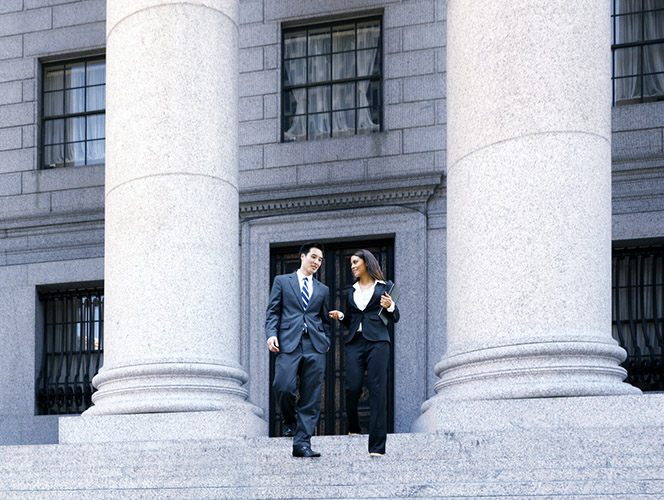two people walking downstairs of federal building