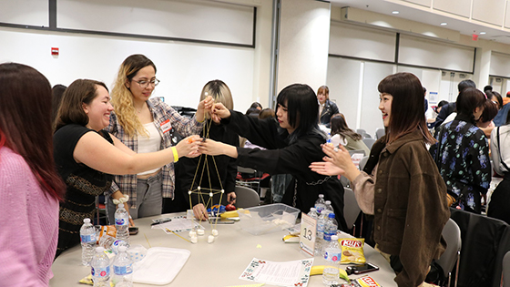 master student building tower with marshmellow