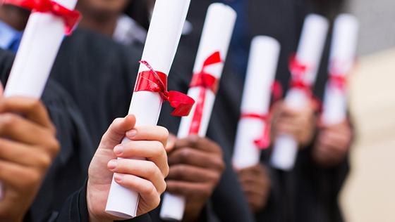 students holding diploma