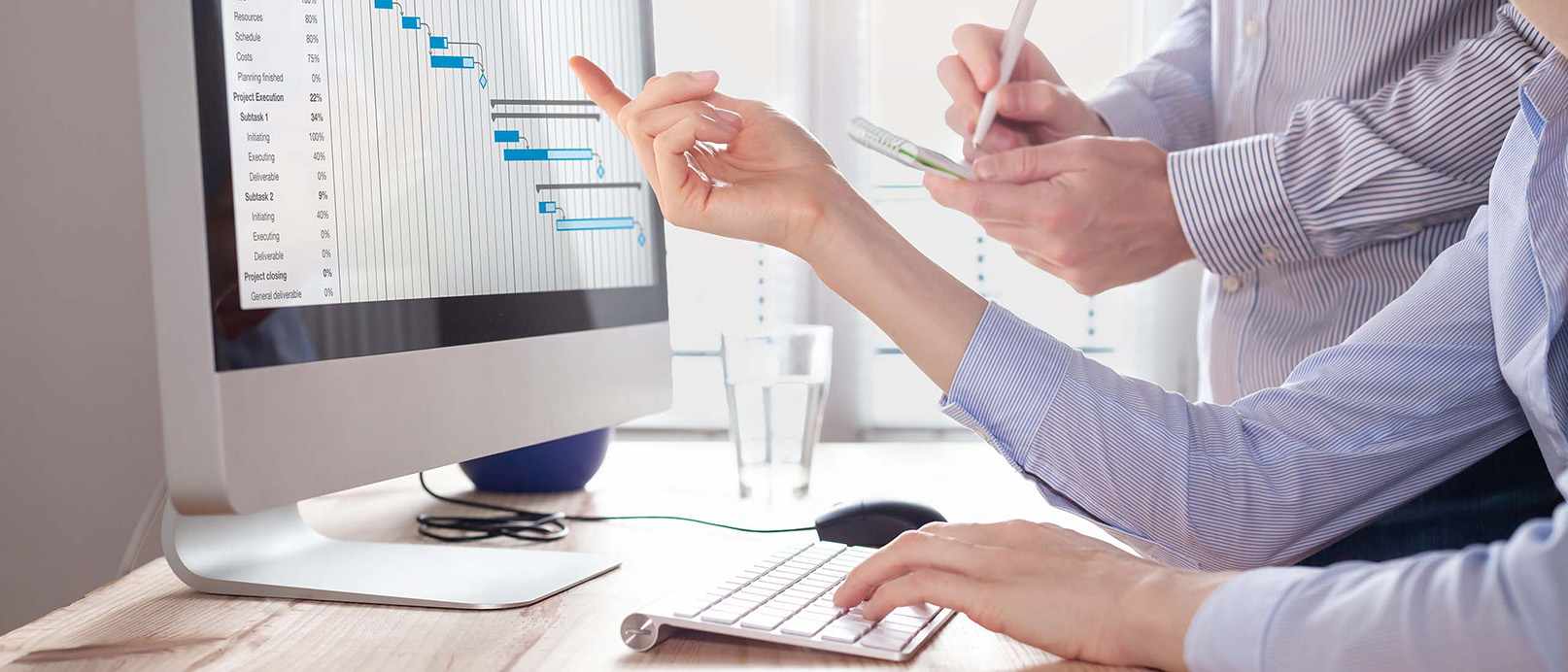 person in front of computer looking at graphs