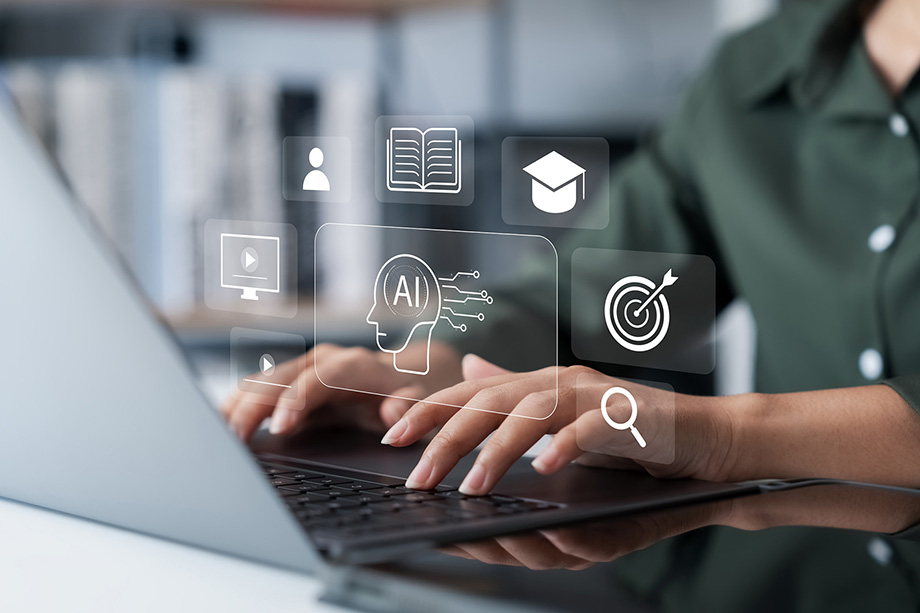 picture of person typing on a computer with icons above it