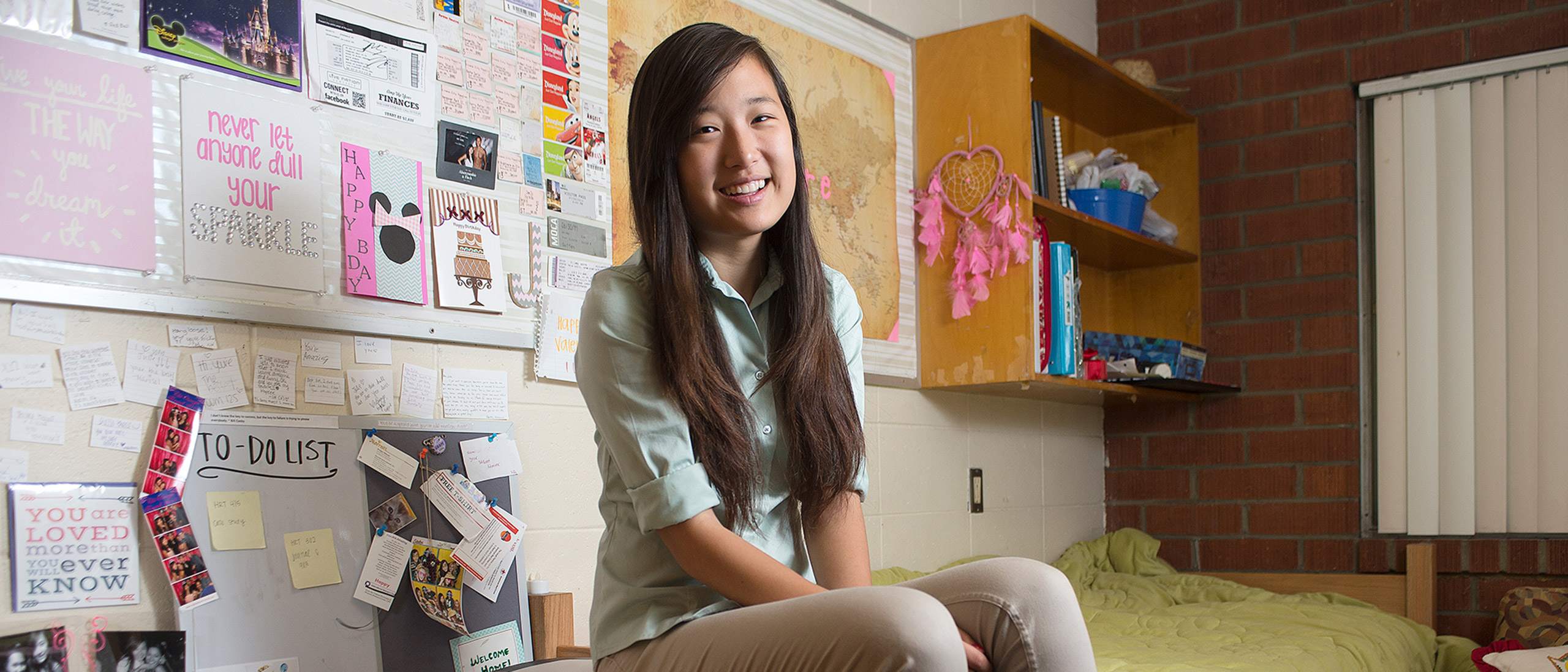 student sitting in room on table