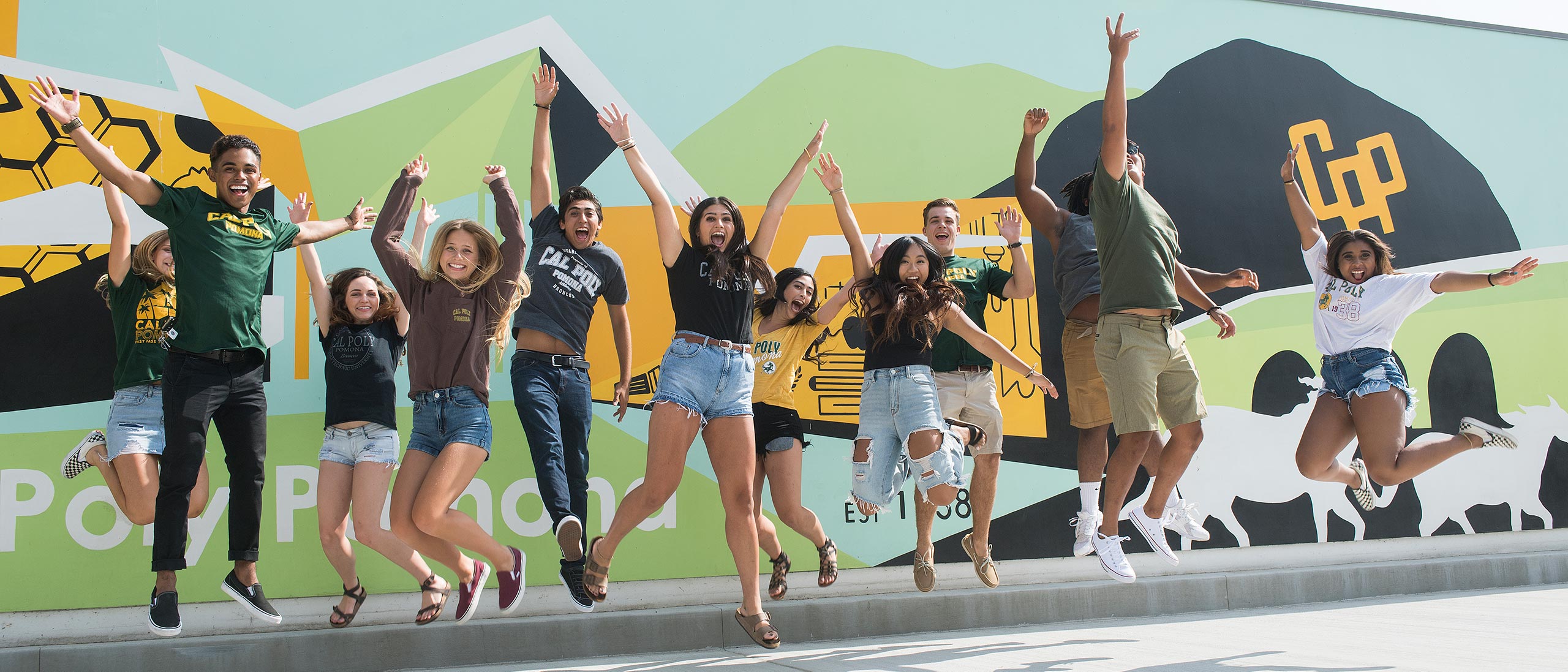 Student Jumping in Front of CPP Mural