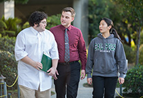 three cpp students walking and talking to each other