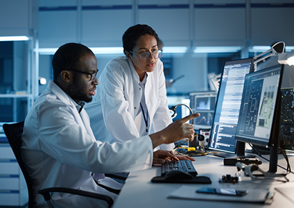 female and male engineer in front of computer