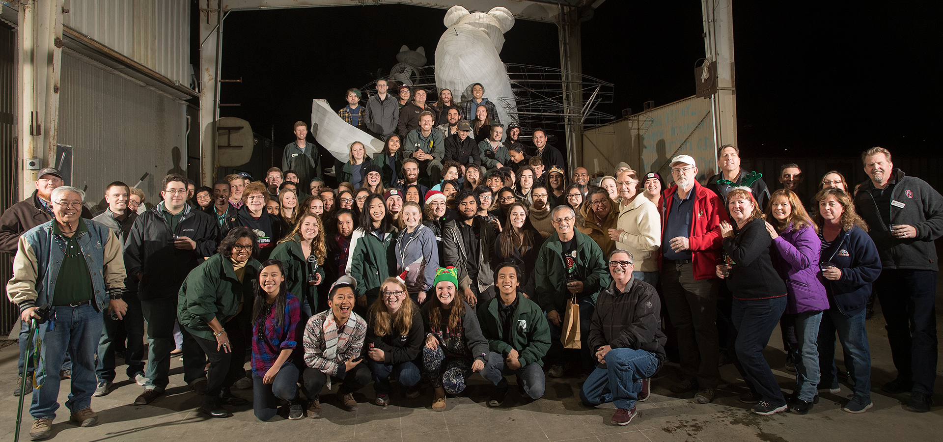 The rose float team poses with Dreams Take Flight float