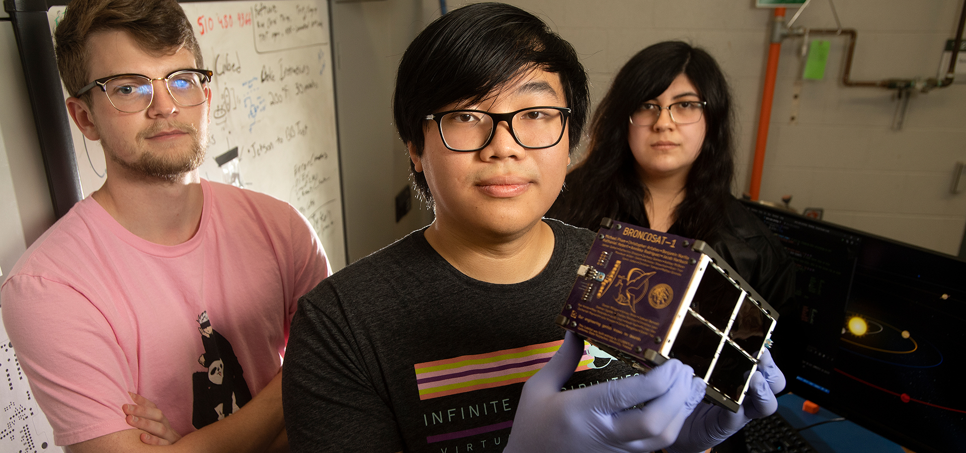 The Bronco Sat Team, Sam Bennett, Katherine Orozco and Michael Pham holding Bronco Sat 1