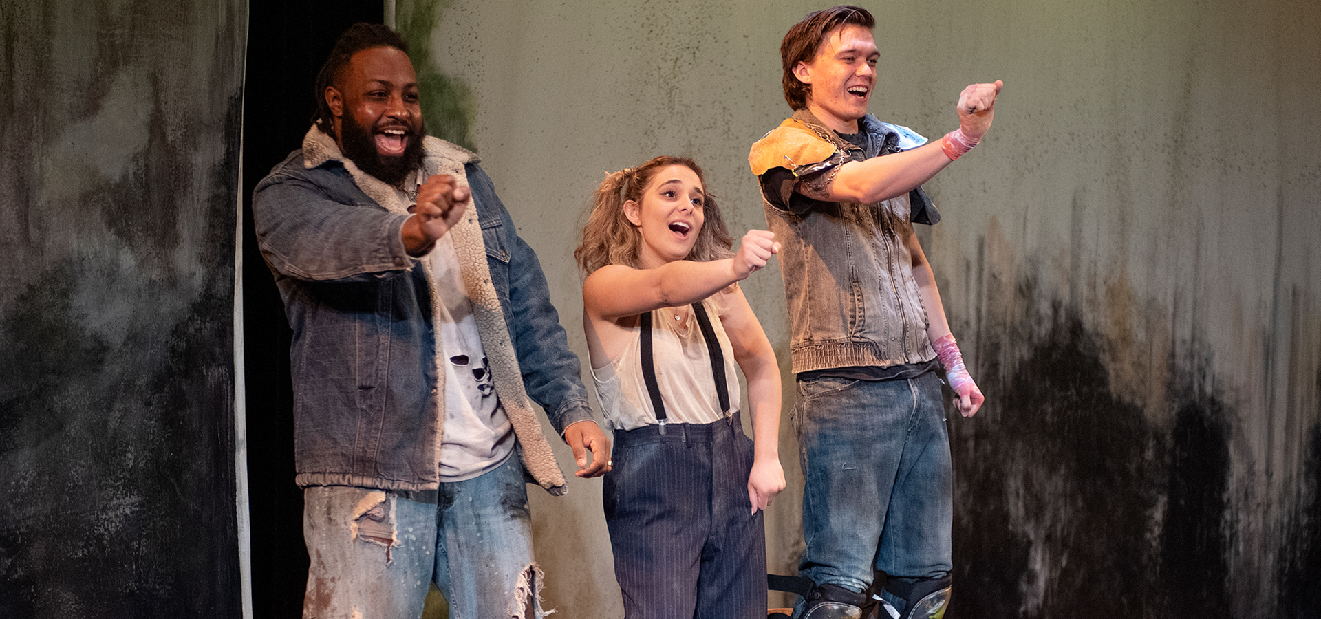 Three cast members dancing 