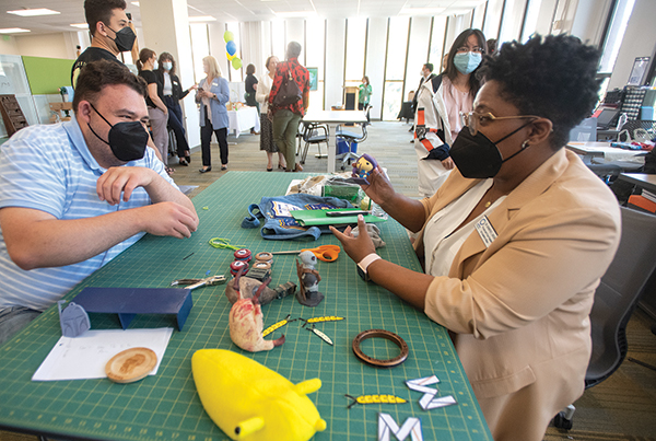 Provost Brown talks with a student at the Maker Studio in the Library. 