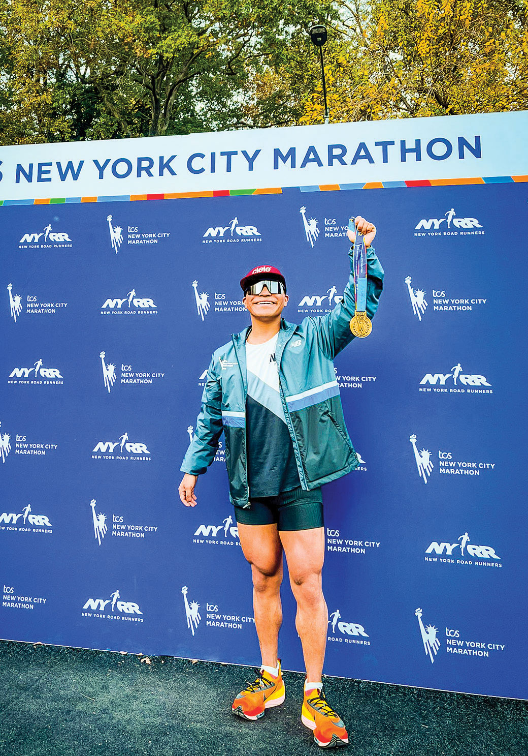 Ramiro poses with his medal after a marathon.