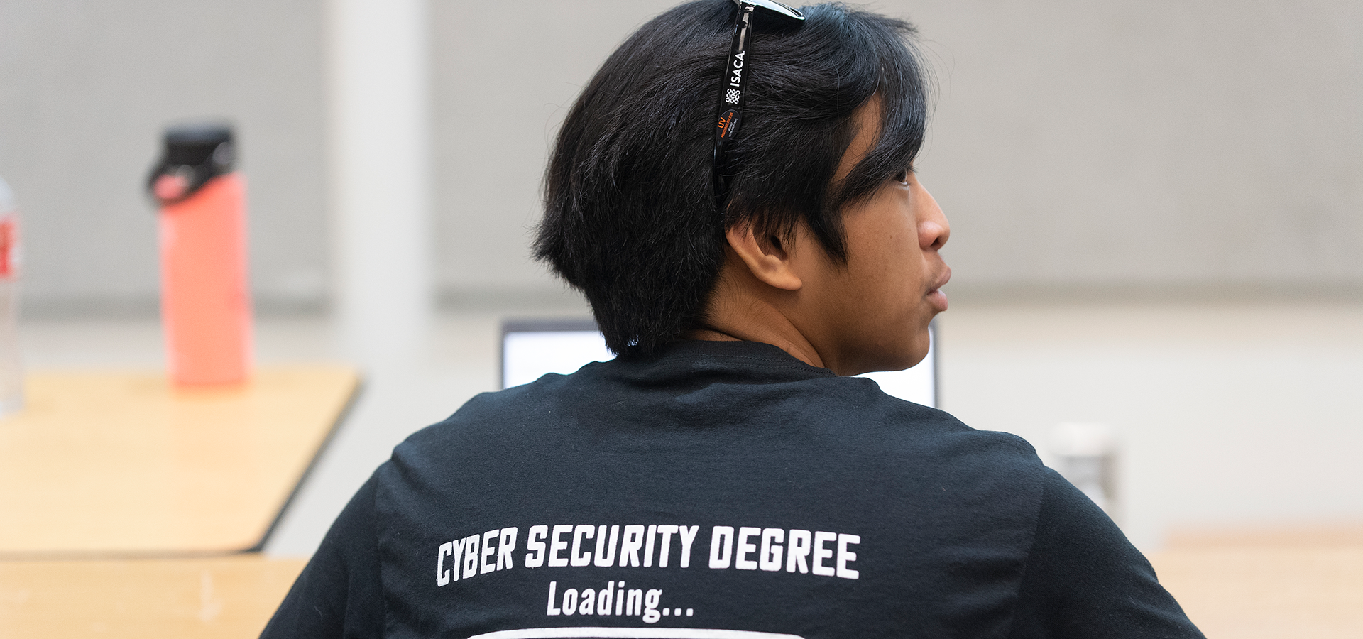 Cyber Security student with a shirt that says Cyber Security Degree loading...