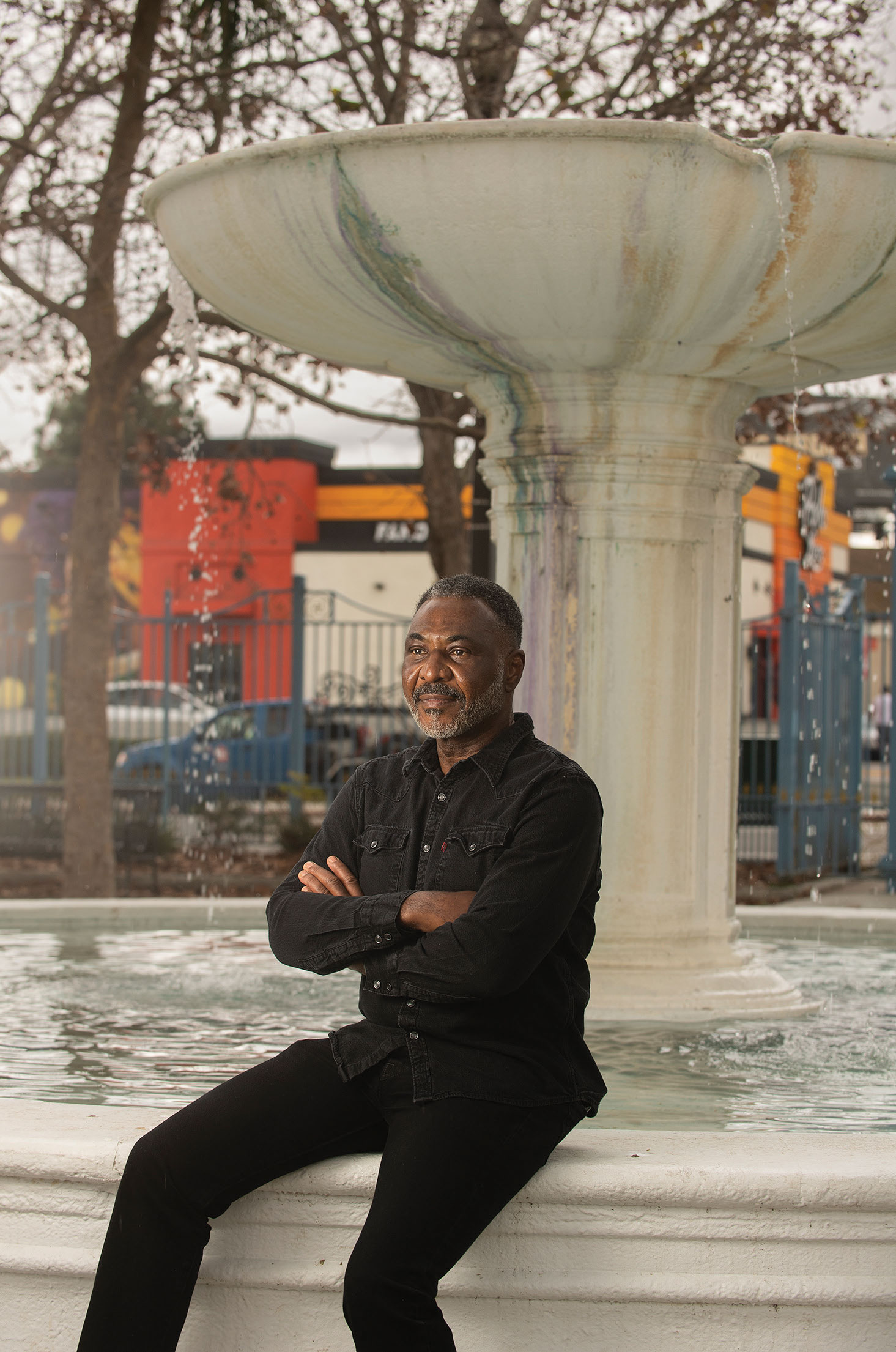 Randal Henry sitting in front of a fountain.