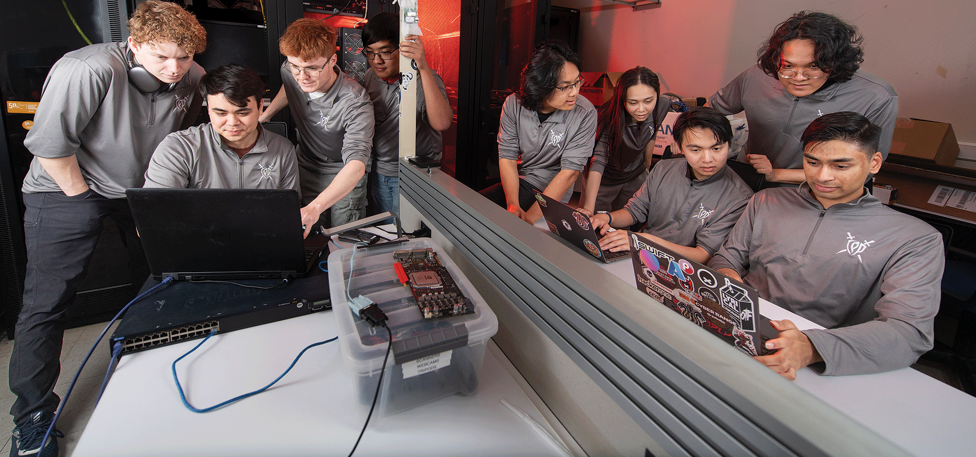 Cyber Team works in the lab on their laptops