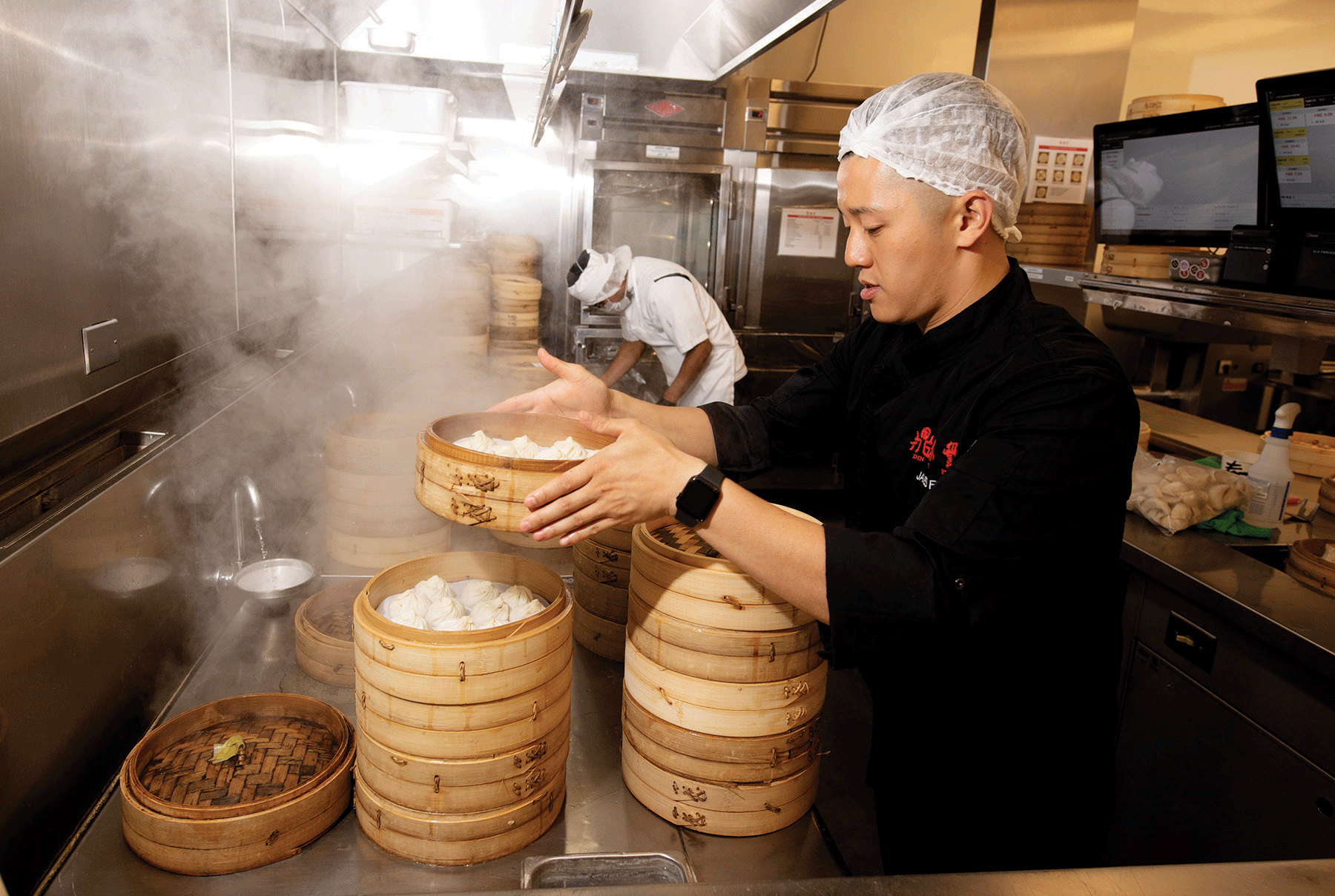 James Fu prepares plates with Bao