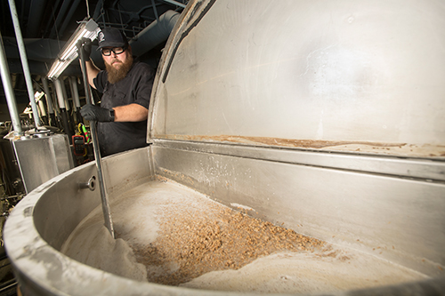 Richard Shaltz stirs the ingredients of beer