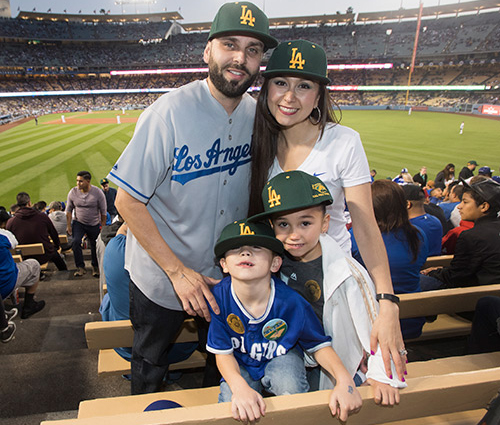 A family of four pose for a photo during CPP night at Dodger Stadium