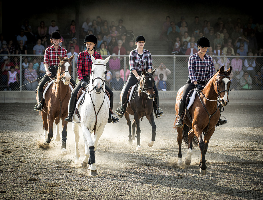 The equestrian drill team performs a Western routine.
