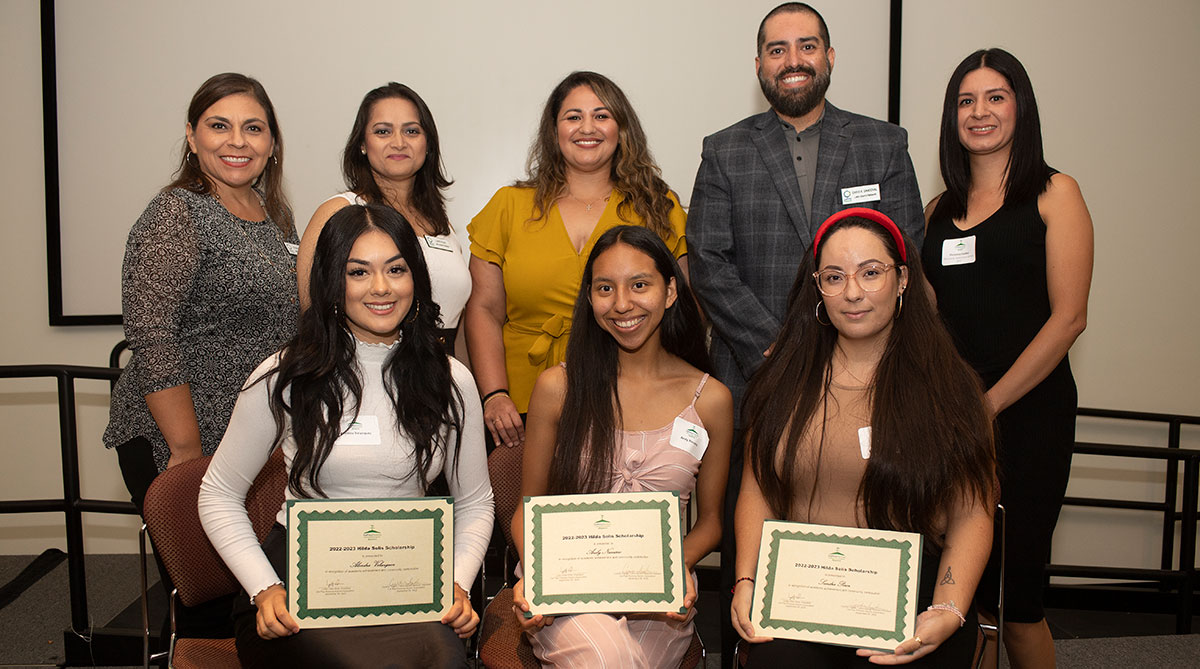 Latin Alumni Network board members, top row, present the Hilda Solis scholarship to students in September