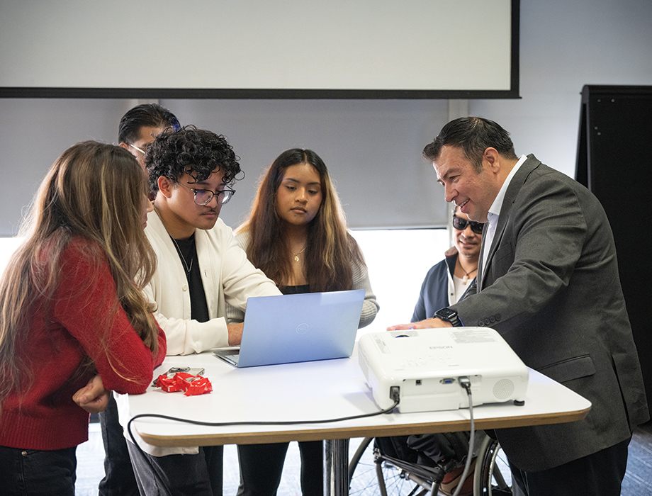 Instructor Jimmy Macias with students in his design studio