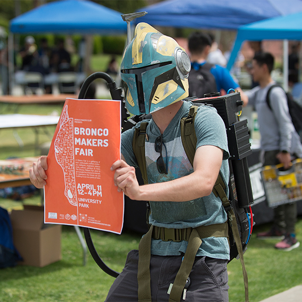 Tucker Dunbar tries to recruit passersby to the Bronco Makers Fair while wearing a Star Wars helmet and a Ghostbusters Proton Pack