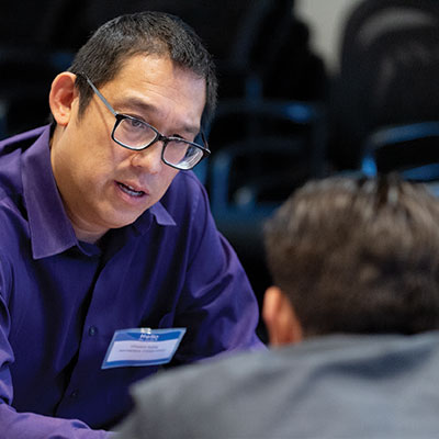 Vicent Kong of Aerospace Corporation talks with students during a resume critique by members of the Advisory Board