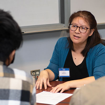 Lam Luu of Skyworks, Inc. talks with students during a resume critique by members of the Advisory Board at the College of Science