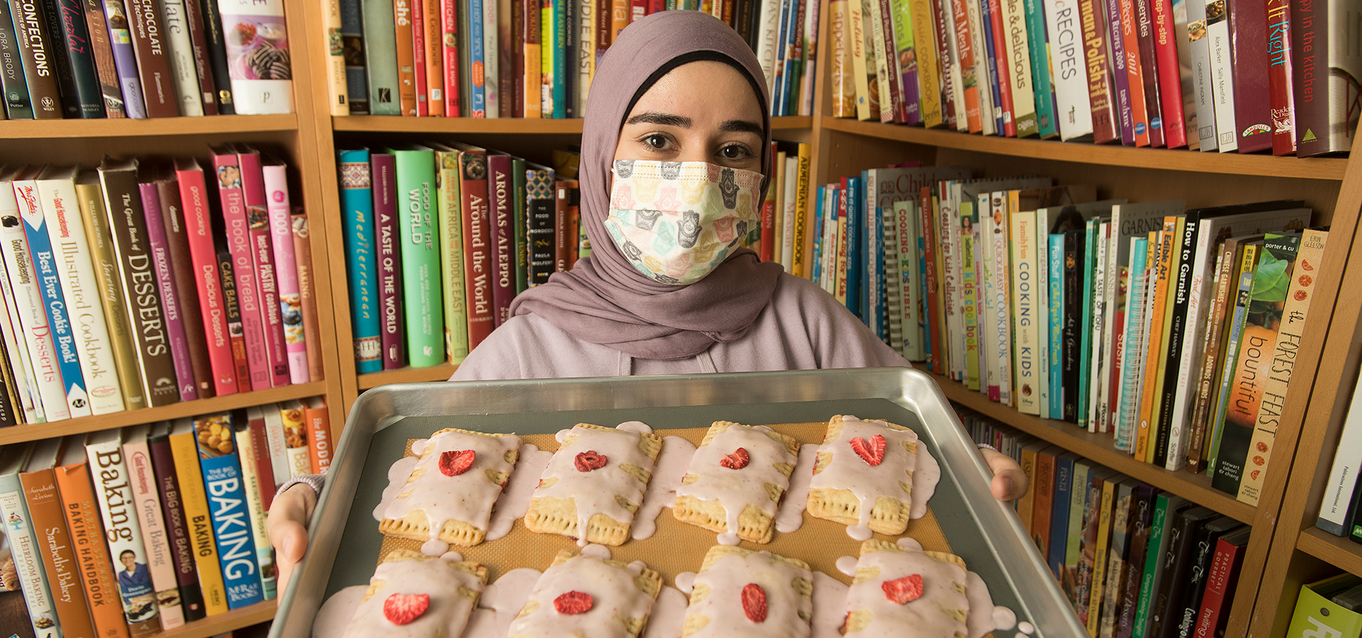Ridha Husna shows off some cookies she baked in her kitchen.