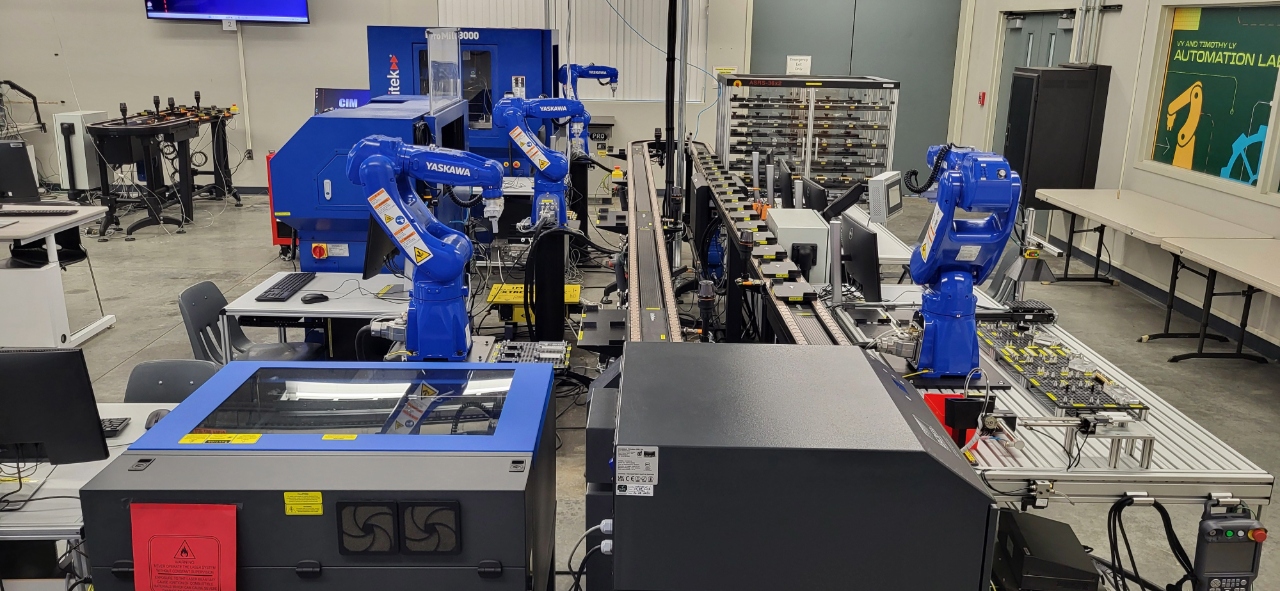 robotic arms in a factory working on a production line