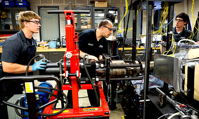 Professor and students working in the lab