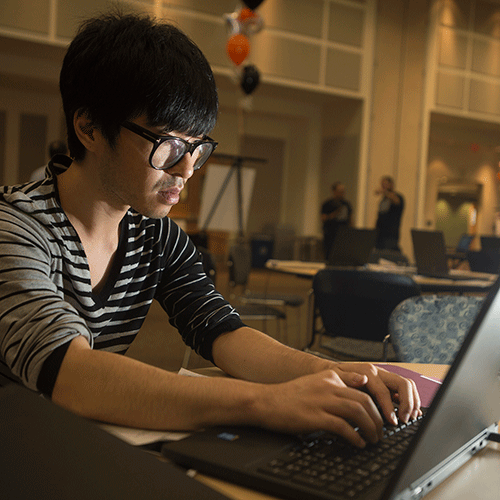  A CIS major, tries to complete a task at the Cyber Security Fair 