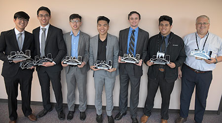 Cyber student team pose with their trophies in a group photo.