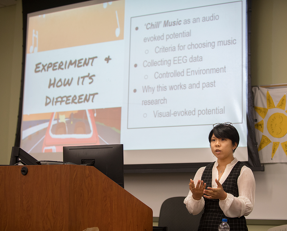 Student gives a presentation by a podium.