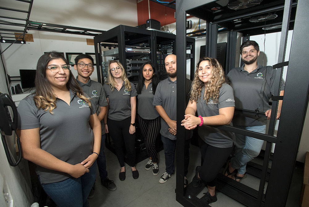 Students pose in the Mitchell C. Hill Student Run Data Center