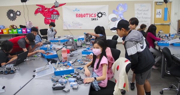 Kids assembling robots in camp