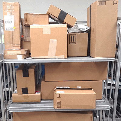 Image of a multi-shelved cart filled with packages