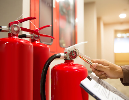 Person inspecting fire extinguisher