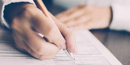 Person writing on Paper with Pen