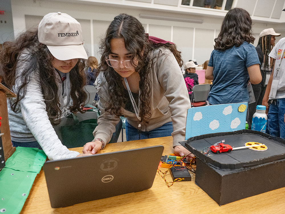 two students work on an engineering project