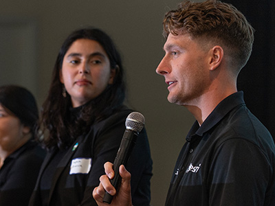 A man speaks into a microphone