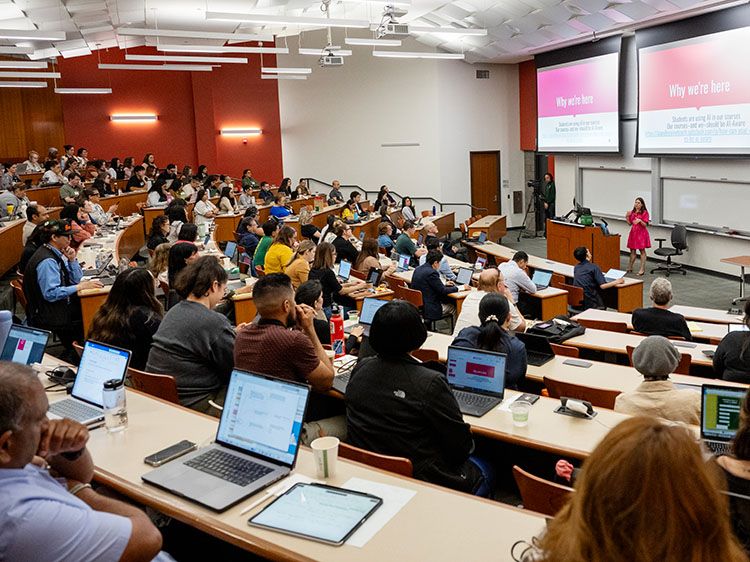 conference attendees seated in a large semiar classroom