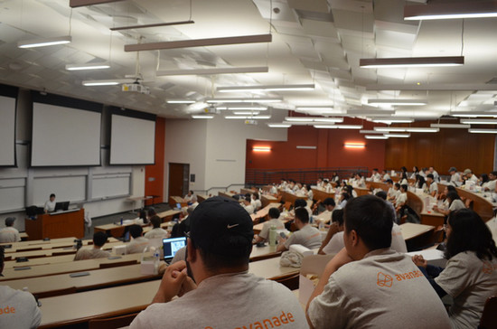 students gathered in a large seminar room