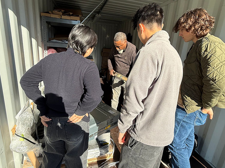 four people unpacking a server donated from Computing for Humanity