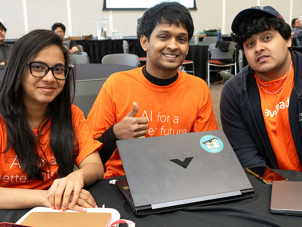 three students seated at a table