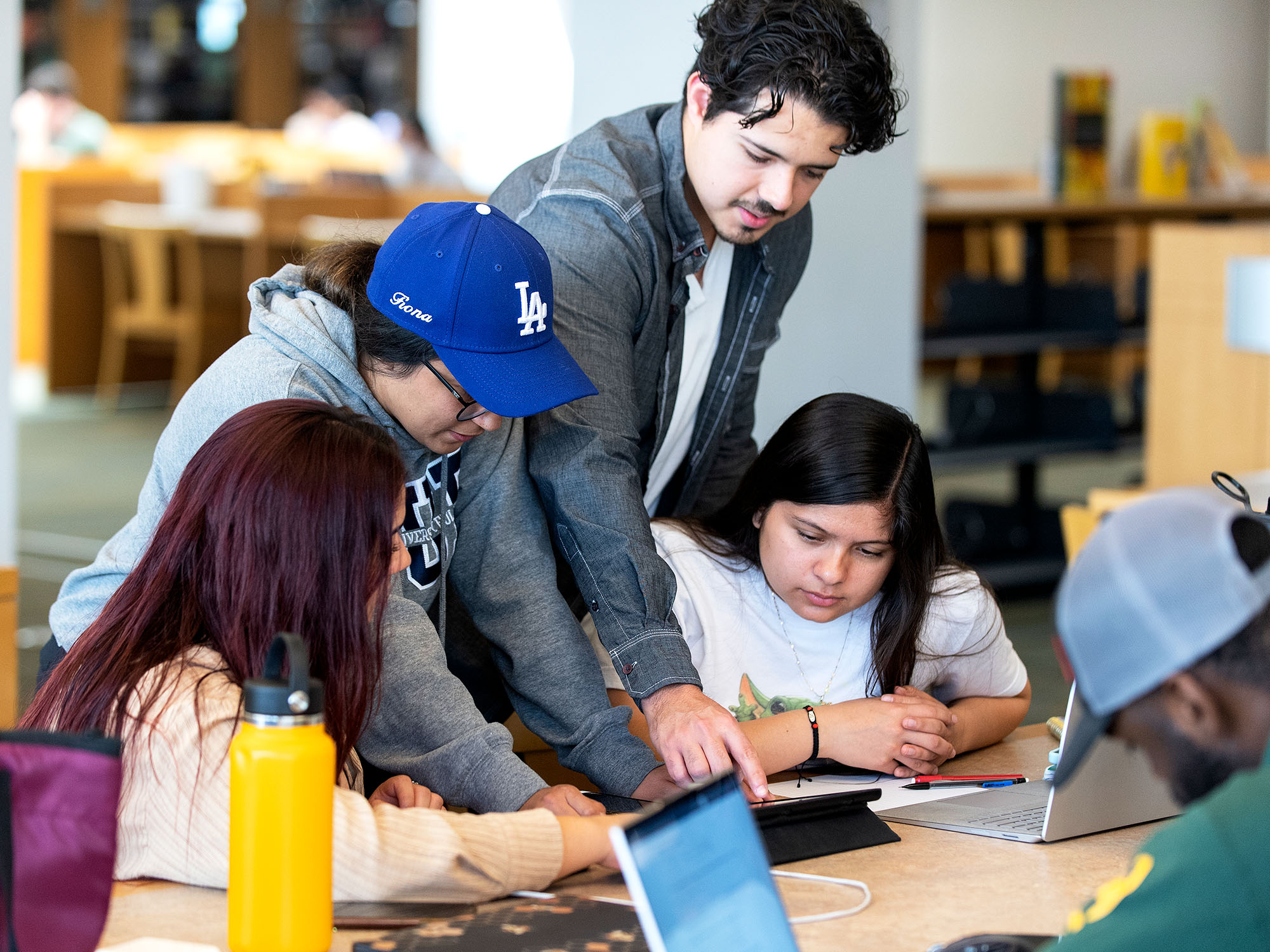 students gathered around an iPad